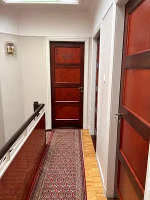 a hallway with a wooden door and a staircase at Dream Home For Tomorrowland in Boom