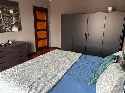 a bedroom with a bed and a dresser and cabinets at Dream Home For Tomorrowland in Boom