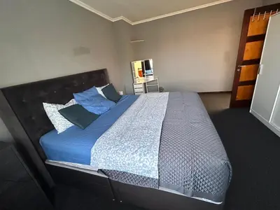 a bedroom with a large bed with blue sheets and pillows at Dream Home For Tomorrowland in Boom