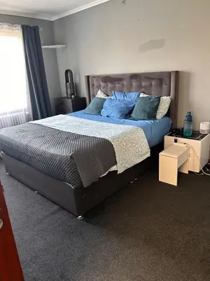 a bedroom with a large bed with blue pillows at Dream Home For Tomorrowland in Boom