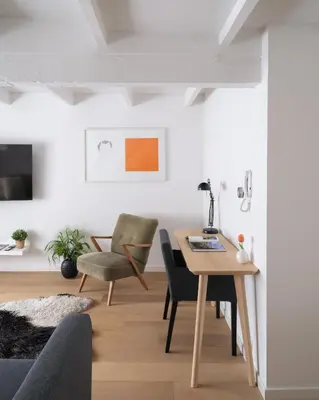 a living room with a wooden table and chairs at Anno in Ghent