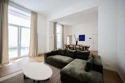 a living room with a couch and a table at Toison d'Or & Sauna in Brussels