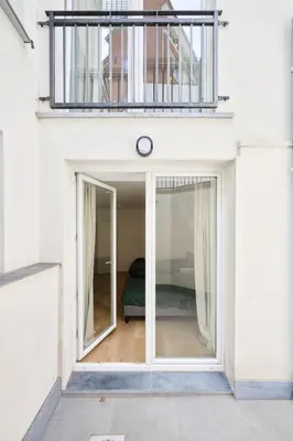 a window in a white building with a bed at Toison d'Or & Sauna in Brussels
