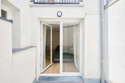 a window in a white building with a door at Toison d'Or & Sauna in Brussels
