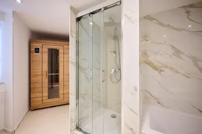 a bathroom with a shower with a glass door at Toison d'Or & Sauna in Brussels