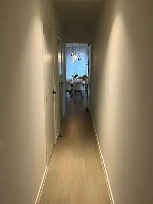 an empty hallway with a table in a dining room at TML Riverside Appartment 2 Bedrooms in Boom