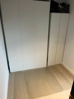 a room with white cabinets and a wooden floor at TML Riverside Appartment 2 Bedrooms in Boom