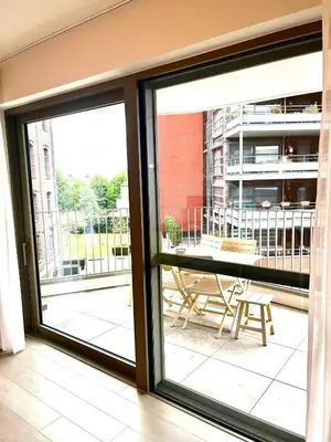 a sliding glass door with a view of a patio at TML Riverside Appartment 2 Bedrooms in Boom