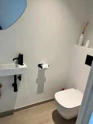a bathroom with a toilet and a sink at TML Riverside Appartment 2 Bedrooms in Boom