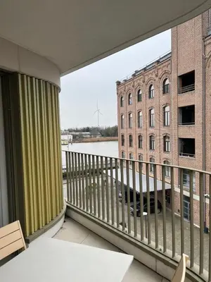 a balcony with a view of a building at TML Riverside Appartment 2 Bedrooms in Boom