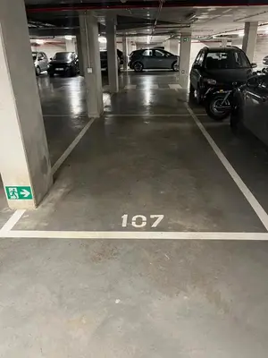 a parking garage with cars parked in it at TML Riverside Appartment 2 Bedrooms in Boom