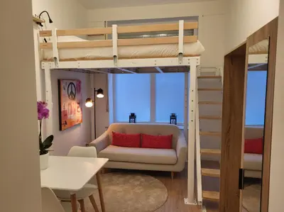 a living room with a bunk bed and a couch at Studio Saintes-Catherine in Brussels
