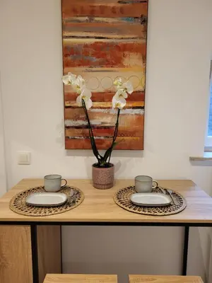 a table with two plates and a plant on it at Studio Saintes-Catherine in Brussels