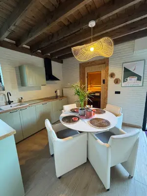 a kitchen and dining room with a table and chairs at Sensi Waters in Duffel