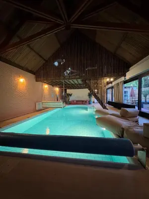 a large swimming pool with couches around it at Sensi Waters in Duffel