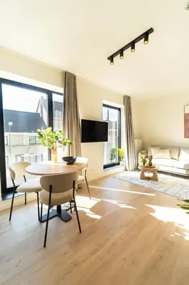 a living room with a table and a couch at Fourstay Luxury City Apartments Diegem - Brussels in Diegem
