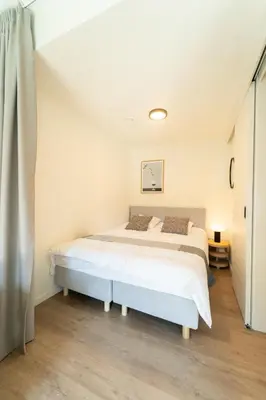 a bedroom with a large white bed in a room at Fourstay Luxury City Apartments Diegem - Brussels in Diegem