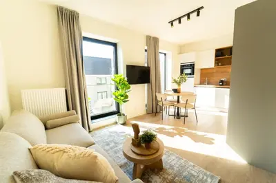 a living room with a couch and a table at Fourstay Luxury City Apartments Diegem - Brussels in Diegem