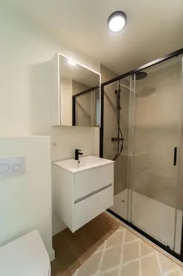 a white bathroom with a sink and a shower at Fourstay Luxury City Apartments Diegem - Brussels in Diegem