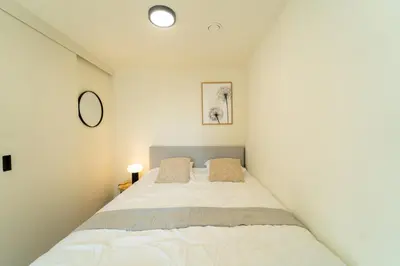 a bedroom with a bed in a white room at Fourstay Luxury City Apartments Diegem - Brussels in Diegem