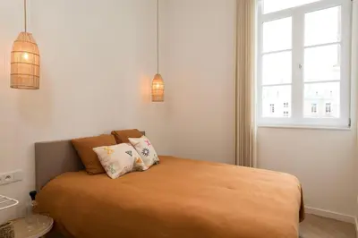 a bedroom with a bed with two pillows on it at NOX Logies, vakantiewoning en polyvalente ruimte in Grimbergen