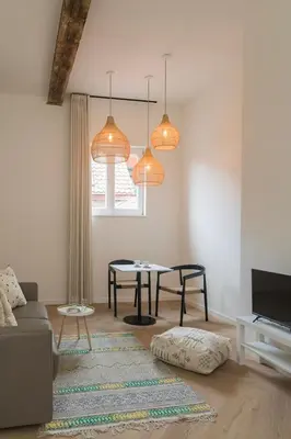a living room with a table and two lights at NOX Logies, vakantiewoning en polyvalente ruimte in Grimbergen