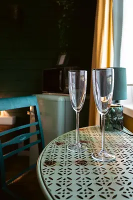 two wine glasses sitting on top of a table at Stijl en kleur in Diest