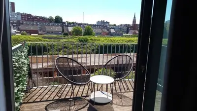 a balcony with two chairs and a view of a city at Apartment Boom 200m from centrm in Boom