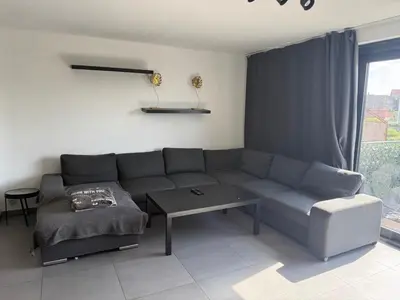 a living room with a couch and a table at Apartment Boom 200m from centrm in Boom