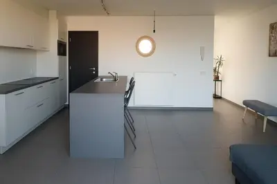 a kitchen with a counter and a sink in a room at Apartment Boom 200m from centrm in Boom