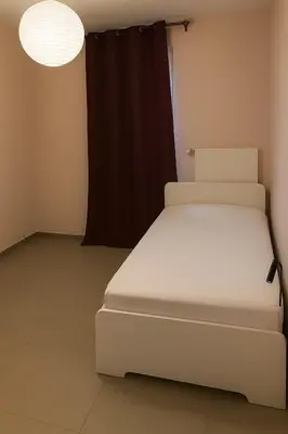 a white bed in a room with a window at Apartment Boom 200m from centrm in Boom