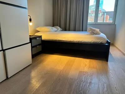 a small bedroom with a bed and a window at Charming apartment in the Heart of Brussels in Brussels
