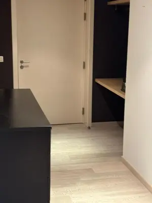 a kitchen with a black counter and a wooden floor at Charming apartment in the Heart of Brussels in Brussels