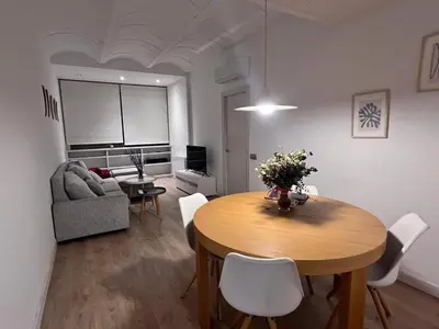 a living room with a table and a couch at Skyline Stay Brussel Elegant Views in Brussels