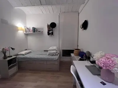 a bedroom with a bed and a desk with a laptop at Skyline Stay Brussel Elegant Views in Brussels