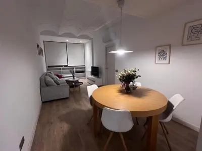a living room with a table and a couch at Skyline Stay Brussel Elegant Views in Brussels