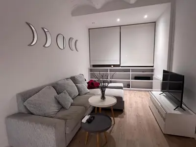 a living room with a couch and a tv at Skyline Stay Brussel Elegant Views in Brussels
