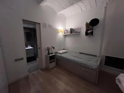 a bedroom with a bed and a bathroom with a sink at Skyline Stay Brussel Elegant Views in Brussels