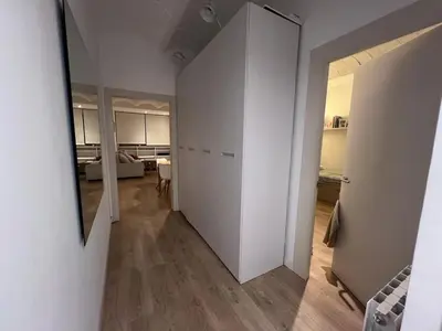 a room with a hallway with white walls and a mirror at Skyline Stay Brussel Elegant Views in Brussels