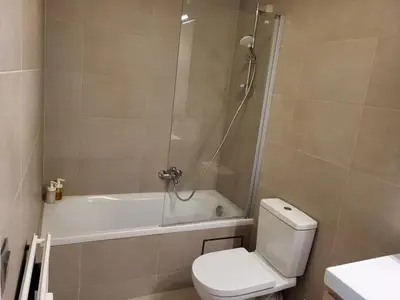a bathroom with a tub and a toilet and a shower at Nice studio EU Quarter in Brussels