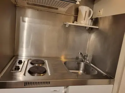 a kitchen with a sink and a stove at Nice studio EU Quarter in Brussels
