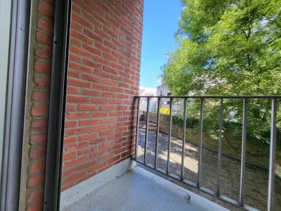 a balcony with a brick wall and a fence at Nice studio EU Quarter in Brussels