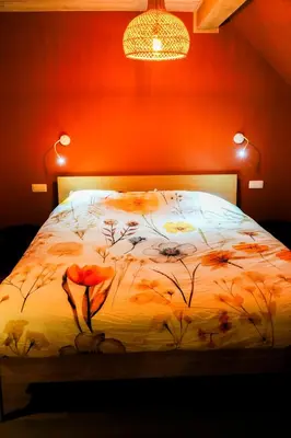 a bedroom with a bed with flowers on it at B&B Heinehoeve in Kaprijke