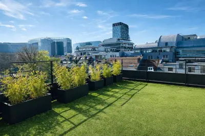 a row of plants on the roof of a building at Stylish Penthouse in BXL with 2 Panoramic Terraces in Brussels