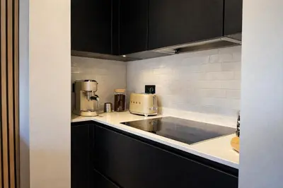 a kitchen with two coffee makers on a counter at Stylish Penthouse in BXL with 2 Panoramic Terraces in Brussels
