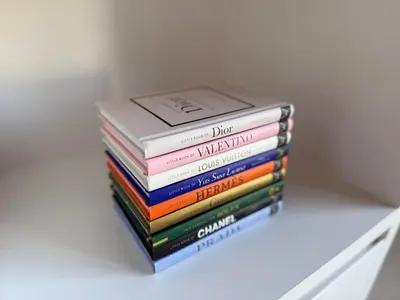 a stack of books sitting on a shelf at Stylish Penthouse in BXL with 2 Panoramic Terraces in Brussels