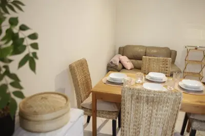 a dining room with a table and chairs and a couch at Sunny Stay & Chill in Brussels