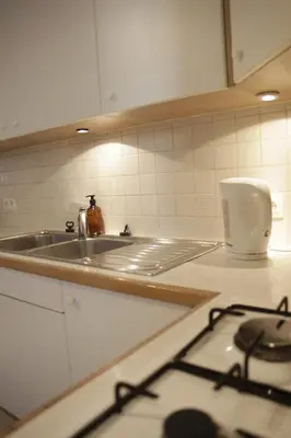 a kitchen counter with a sink and a stove at Sunny Stay & Chill in Brussels