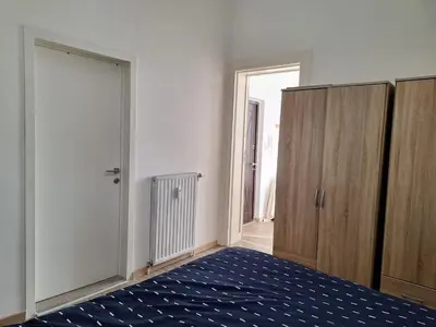 a room with a bed and a closet and a door at Midi Gateway in Brussels