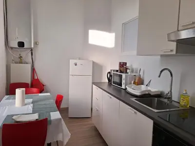a kitchen with a sink and a white refrigerator at Midi Gateway in Brussels